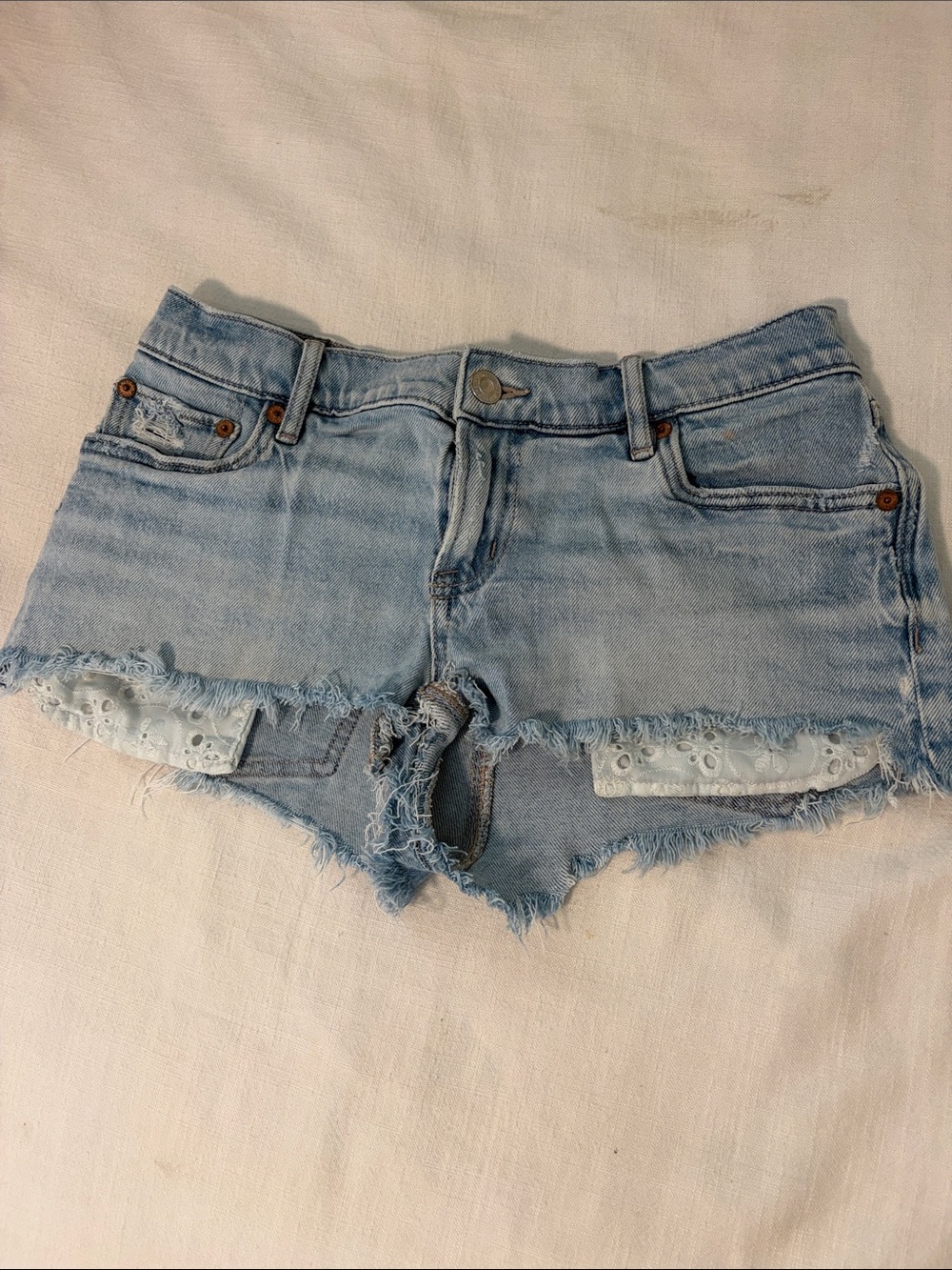 Women's Light Blue Distressed Denim Cutoff Shorts with Eyelet Trim